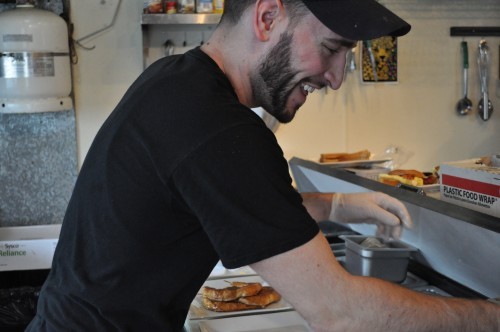 The People's Kitchen cook Mark Emeigh prepares food in the small kitchen to send out to customers on March 1, 2015.